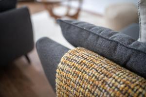 a close up of a couch with a pillow at End House Inverness in Inverness