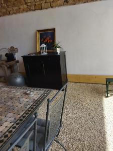 a room with a black dresser and a wall at La ferme du vincent in Liergues