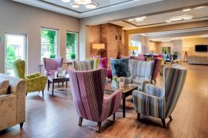 a waiting room with chairs and a table and a waiting room at Citi Hotel's Warszawa-Falenty in Raszyn