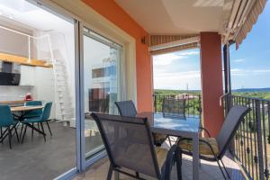 a room with a balcony with a table and chairs at Gallery apartment in Skrbcici (Krk) in Skrbčići