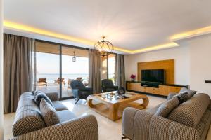 a living room with two couches and a table at Water Edge 1 in Kaş