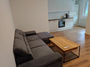 a living room with a couch and a coffee table at Sommerresidenz 9210 in Pörtschach am Wörthersee