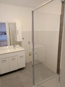 a bathroom with a glass shower and a sink at Sommerresidenz 9210 in Pörtschach am Wörthersee