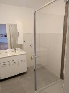 a bathroom with a glass shower and a sink at Sommerresidenz 9210 in Pörtschach am Wörthersee +10 photos