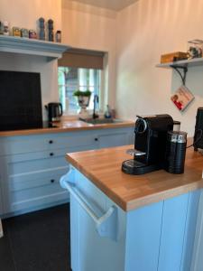 a kitchen with a counter with a coffee maker on it at Huisje Boompje Beerze in Beerze