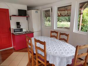 a kitchen with a table and chairs in a room at Green Eden Lepsa 2 in Lepşa +12 photos