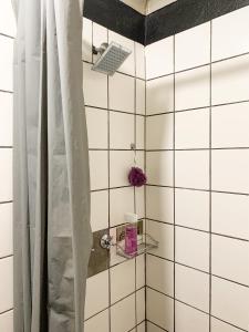 a bathroom with a shower with white tiled walls at Havana Nights in Graskop