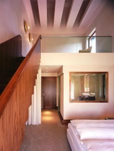 a room with two beds and a stair case at Seehotel Am Neuklostersee in Neukloster