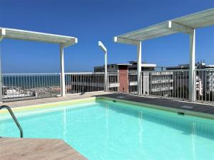 a swimming pool on the roof of a building at Residence Ten Suite in Rimini