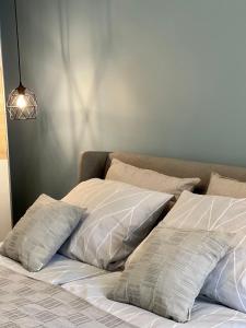 a bed with two pillows on top of it at Chernomorets Apartment in Chernomorets
