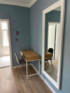 a dining room with a table and a mirror at Chernomorets Apartment in Chernomorets