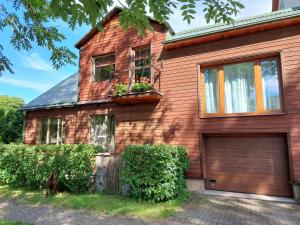 a house with a garage and a dog in front of it at Quiet place in Kaunas