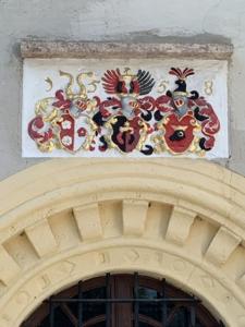 un bâtiment avec un tableau au-dessus d'une porte dans l'établissement Rittergut Schloss Niederforchheim, à Forchheim