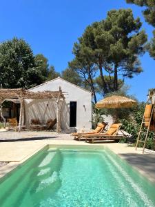 a swimming pool in front of a white building at l'Amarantine in La Ciotat