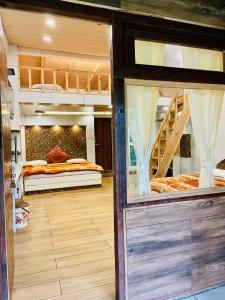 a room with two bunk beds and a window at Hotel sun paradise in Nainital