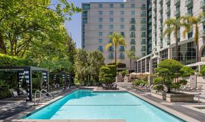 a swimming pool with chairs and a building at Hyatt Regency Sacramento in Sacramento