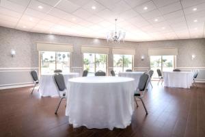 a conference room with white tables and chairs at The Volare, Ascend Hotel Collection in San Clemente