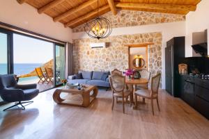 a living room with a blue couch and a table at Water Edge 3 in Kaş