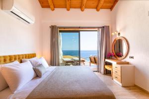 a bedroom with a bed and a view of the ocean at Water Edge 3 in Kaş +15 photos