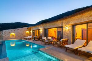 a villa with a swimming pool next to a building at Water Edge 3 in Kaş