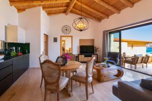 a kitchen and living room with a table and chairs at Water Edge 3 in Kaş
