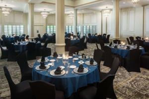 a banquet hall with blue tables and chairs at The Elms Hotel & Spa, a Destination by Hyatt Hotel in Excelsior Springs