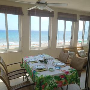 a dining room with a table with a view of the beach at Agua Marina in Arenales del Sol