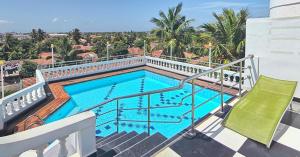 a swimming pool on the balcony of a house at Royal Castle Hotel in Negombo
