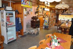 a room with a table and a refrigerator in a store at Penzion54 & Restaurace in Ostrov