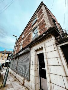 a brick building with a door and a garage at The County Staycation in Liverpool