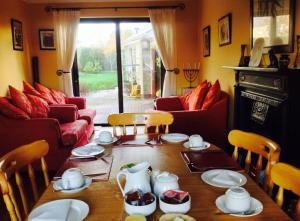 a dining room with a table with dishes on it at Doogarry House B&B in Castlebar