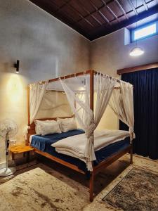 a bedroom with a bed with a canopy at Deodar Homestay in Almora