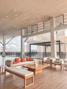 a living room with couches and tables in a building at The Nook at Serin Tagaytay in Tagaytay