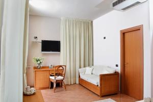 a hotel room with a bed and a desk and a chair at Tenuta Re Ferdinando in Santa Maria Capua Vetere