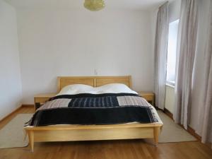 1 dormitorio con 1 cama en una habitación con ventana en Aich21, en Peißenberg