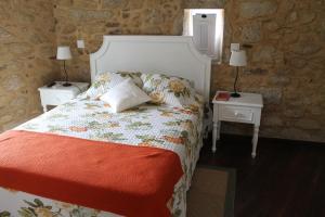 a bedroom with a bed with two nightstands and two lamps at Quinta Anna Horvath in Vale de Cambra +52 photos