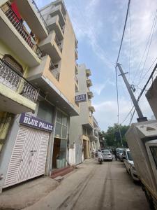 a building on a street with a blue parking lot at Hotel Blue Palace By WB Inn in New Delhi