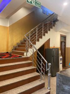 a staircase with a refrigerator in a building at Hotel Blue Palace By WB Inn in New Delhi