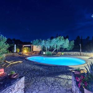 a swimming pool in a yard at night at Villa Oxa Dreamland in Stari Grad