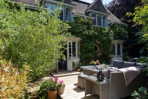 a patio with a table and chairs in front of a house at Anoush in Everton