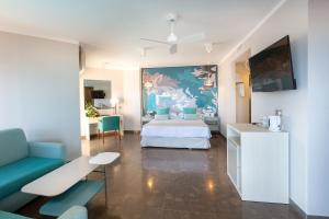 a hotel room with a bed and a couch at Hotel Angela - Adults Recommended in Fuengirola