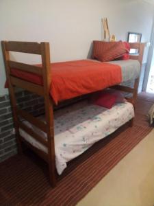 two bunk beds in a room with a platform bed at BohippienJBAY in Jeffreys Bay