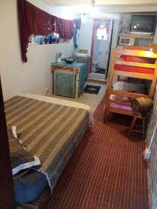 a bedroom with two bunk beds and a ladder at BohippienJBAY in Jeffreys Bay