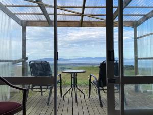 a patio with chairs and a table on a deck at Wilsons Prom Views - Prom View Shack 