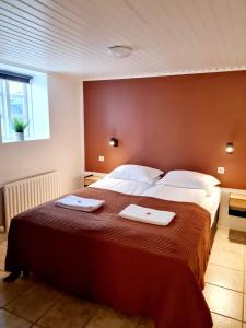 Postel nebo postele na pokoji v ubytování Grettir Guesthouse Downtown Charm
