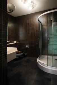 a bathroom with a tub, shower, and sink at Weekend Boutique Hotel in Chişinău