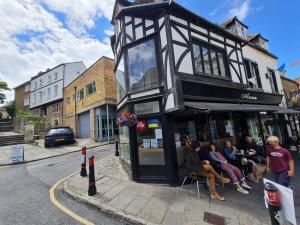 a group of people sitting outside of a building at The Undercoft luxury private studio at The Old Church House central Frome in Frome