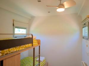 a room with bunk beds and a ceiling fan at El Vagón de Baides in Baides