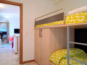 a bedroom with bunk beds with a door leading into a room at El Vagón de Baides in Baides