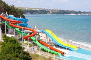 a water slide at a water park next to the ocean at Sol Luna Bay All Inclusive in Obzor